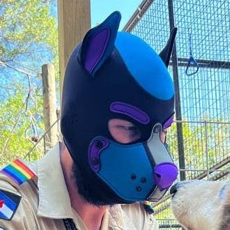 Community member in a blue and black pup hood