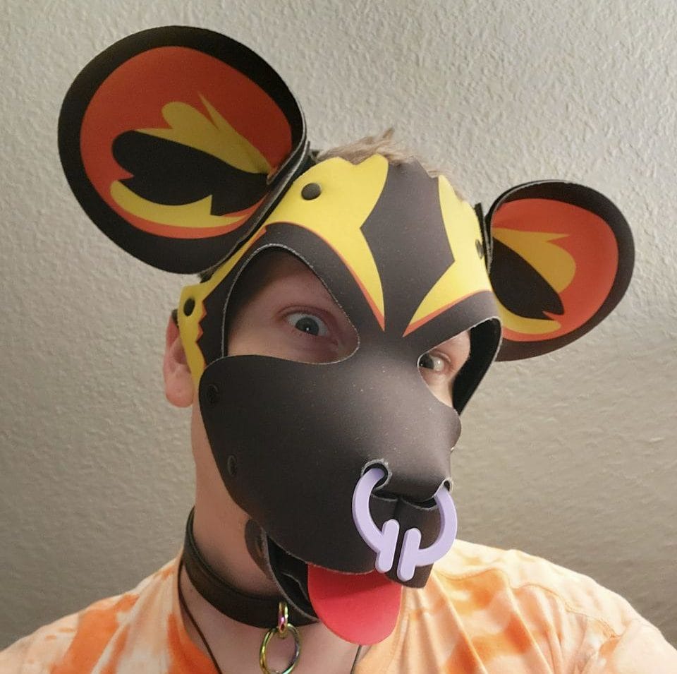 Community member in a pup hood